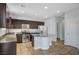 Kitchen boasts granite countertops, stainless steel appliances, dark wood cabinets and center island at 5852 Brown Tree Ln, North Las Vegas, NV 89081