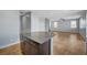 Open-concept kitchen features a center island with granite countertop and a seamless flow to the living area at 5852 Brown Tree Ln, North Las Vegas, NV 89081