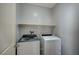 Conveniently located laundry room includes modern washer and dryer units and a storage shelf at 5852 Brown Tree Ln, North Las Vegas, NV 89081