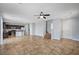 Large living area flows into the kitchen with staircase on right and neutral wall paint at 5852 Brown Tree Ln, North Las Vegas, NV 89081