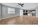Open-concept living space featuring tile flooring, lots of windows and adjacent modern kitchen at 5852 Brown Tree Ln, North Las Vegas, NV 89081