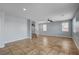 Large living area with tile floors, two windows, ceiling fan and staircase on left at 5852 Brown Tree Ln, North Las Vegas, NV 89081
