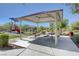 A covered picnic shelter featuring multiple tables and seating, perfect for outdoor gatherings and relaxation at 5852 Brown Tree Ln, North Las Vegas, NV 89081