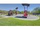 A community playground with slides, climbing structures, and shaded seating areas provides a fun space for children at 5852 Brown Tree Ln, North Las Vegas, NV 89081