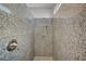 Modern walk-in shower with a granite tiled interior and chrome fixtures at 5852 Brown Tree Ln, North Las Vegas, NV 89081