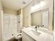 Well-lit bathroom with modern vanity, mirror, and walk-in shower at 6420 Little Pine Way, Las Vegas, NV 89108