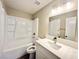 A clean, bright bathroom features a modern vanity, mirror, and shower-tub combo at 6420 Little Pine Way, Las Vegas, NV 89108