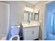 Updated bathroom featuring a modern vanity, sleek mirror, and bright lighting at 6420 Little Pine Way, Las Vegas, NV 89108
