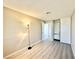 This bedroom features gray wood flooring, an organized closet, and a floor lamp that provide ample light at 6420 Little Pine Way, Las Vegas, NV 89108