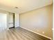 A bedroom featuring light gray wood flooring, an organized closet, and plenty of natural light at 6420 Little Pine Way, Las Vegas, NV 89108