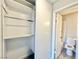 An open closet with a view of the toilet and shower in a small bathroom at 6420 Little Pine Way, Las Vegas, NV 89108