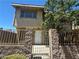 Charming two-story home featuring a gated entrance, stucco exterior and mature trees at 6420 Little Pine Way, Las Vegas, NV 89108