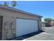Garage at 6420 Little Pine Way with white door and neutral siding under a bright, sunny sky at 6420 Little Pine Way, Las Vegas, NV 89108
