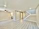 Spacious living room features light gray laminate flooring, fresh paint, and staircase to the second floor at 6420 Little Pine Way, Las Vegas, NV 89108