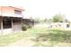 Fenced backyard with pergola-covered patio and lush green grass at 721 Bourbon St # F2, Pahrump, NV 89048