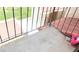 Balcony with red tiled roofing is enclosed with a black railing and features a nearby green space at 721 Bourbon St # F2, Pahrump, NV 89048