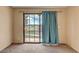Carpeted bedroom features sliding glass doors and neutral walls at 721 Bourbon St # F2, Pahrump, NV 89048