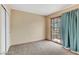 Carpeted bedroom features sliding glass doors and neutral walls at 721 Bourbon St # F2, Pahrump, NV 89048