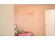 Bright bedroom showcases a floral wall design, cozy bed, and plush stuffed animals at 721 Bourbon St # F2, Pahrump, NV 89048