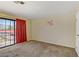Bedroom featuring carpet, sliding glass doors and neutral walls at 721 Bourbon St # F2, Pahrump, NV 89048