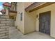 Townhome entrance featuring a secure wrought iron gate and manicured landscaping at 721 Bourbon St # F2, Pahrump, NV 89048