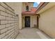 Inviting front entrance with red tile roof and a secure decorative metal gate at 721 Bourbon St # F2, Pahrump, NV 89048