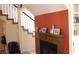 Inviting fireplace with a wooden mantle, flanked by a staircase and a built-in shelving unit at 721 Bourbon St # F2, Pahrump, NV 89048