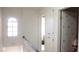 Hallway with a charming arched window, linen closet, and a bedroom door decorated with flowers at 721 Bourbon St # F2, Pahrump, NV 89048