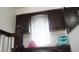 This home office boasts a dark wood desk, upper cabinets, and a bright window view at 721 Bourbon St # F2, Pahrump, NV 89048