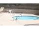 Close-up of in-ground hot tub with steel hand rail and lounge chairs in the background at 721 Bourbon St # F2, Pahrump, NV 89048