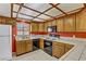 A functional kitchen with essential appliances, white tile countertops, and wood cabinets, offering a practical cooking space at 721 Bourbon St # F2, Pahrump, NV 89048