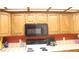 Kitchen featuring white appliances and wood cabinets with a microwave at 721 Bourbon St # F2, Pahrump, NV 89048