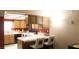 Spacious kitchen featuring wood cabinets, tile countertops, breakfast bar, and an open design for easy entertaining at 721 Bourbon St # F2, Pahrump, NV 89048