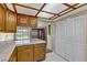 A charming kitchen featuring white tile countertops, wood cabinets, and large windows with golf course views at 721 Bourbon St # F2, Pahrump, NV 89048