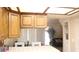 Bright kitchen features tile countertops, wood cabinets and a sunlit eat-in area with comfortable white chairs at 721 Bourbon St # F2, Pahrump, NV 89048