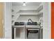 Modern laundry closet showcasing brand new washer and dryer with storage, offering functionality and convenience at 721 Bourbon St # F2, Pahrump, NV 89048