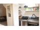 Efficient laundry room features modern washer/dryer units, built-in shelving, and easy access to additional storage space at 721 Bourbon St # F2, Pahrump, NV 89048