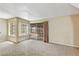 Bright living room with large windows and sliding glass doors to outdoor space at 721 Bourbon St # F2, Pahrump, NV 89048