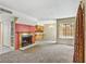 Spacious carpeted living room with natural light and a cozy fireplace at 721 Bourbon St # F2, Pahrump, NV 89048