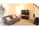 Spacious living area with a TV, a comfortable sofa, and ample natural light at 721 Bourbon St # F2, Pahrump, NV 89048