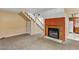 Living room featuring a fireplace, open staircase, and easy access to the kitchen at 721 Bourbon St # F2, Pahrump, NV 89048