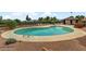 Large community pool with lounge chairs surrounded by well-maintained landscaping at 721 Bourbon St # F2, Pahrump, NV 89048