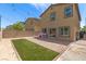 Private backyard with artificial grass, patio, and string lights, perfect for outdoor entertaining at 7819 Rachelis St, North Las Vegas, NV 89084