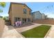 Back of home with patio, small patch of artificial turf, and decorative outdoor lighting at 7819 Rachelis St, North Las Vegas, NV 89084