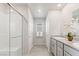 Bright bathroom with a glass-enclosed shower, dual sinks, and modern finishes at 7819 Rachelis St, North Las Vegas, NV 89084