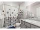 Bathroom featuring vanity, granite countertop, toilet, and shower with decorated curtain at 7819 Rachelis St, North Las Vegas, NV 89084
