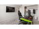 Bedroom features a large TV, closet, and desk with gaming chair, perfect for relaxing at 7819 Rachelis St, North Las Vegas, NV 89084