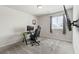 A spacious bedroom with a window and gaming setup, perfect for work or play at 7819 Rachelis St, North Las Vegas, NV 89084