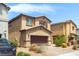 Inviting two-story home with a two-car garage and fresh landscaping at 7819 Rachelis St, North Las Vegas, NV 89084