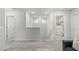 Hallway with neutral carpet, white doors, and access to the laundry room upstairs at 7819 Rachelis St, North Las Vegas, NV 89084